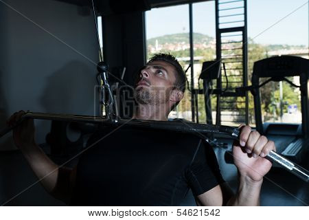 Bodybuilder Doing Heavy Weight Exercise For Back