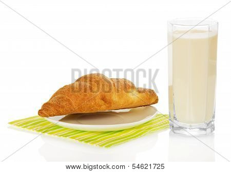 Glass of milk and croissant on a napkin