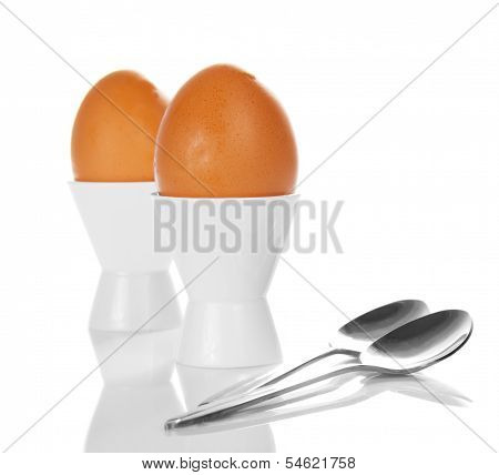 Brown eggs in white egg cups