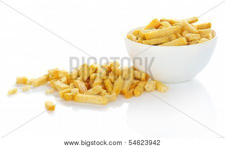 Croutons which have dropped out of a bowl