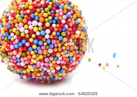 a ball coated with nonpareils of different colors on a white background