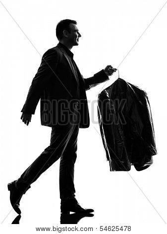 one caucasian business man holding dry clean clothes in silhouette  on white background