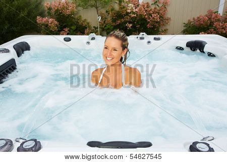 Beautiful woman relaxing in a hot tub. Vacation.