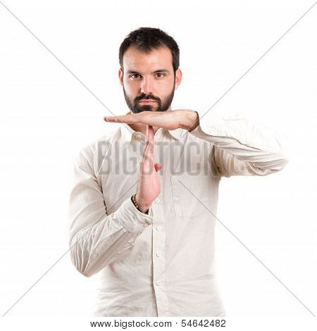 Young Man Doing The Timeout Sign Over White Background