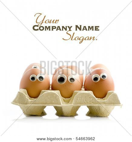 A group of eggs in a box with funny eyes 