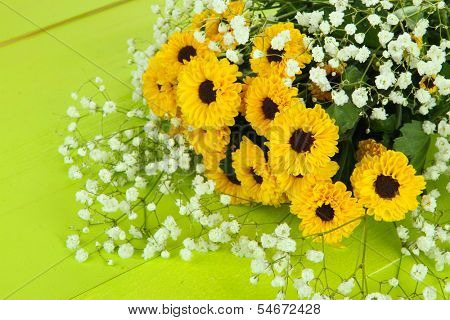 Beautiful flowers on wooden background