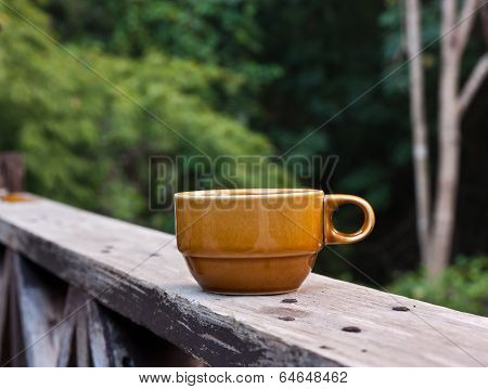 Coffee On Balcony Fence.
