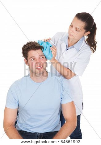 Doctor Giving Treatment To Patient