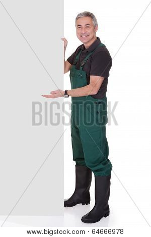 Mature Male Gardner Holding Placard