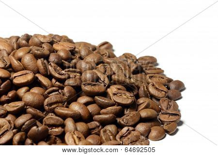 Hill of brown coffee beans isolated on white