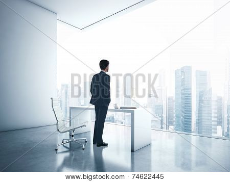 Businessman Looking Megalopolis Through Window