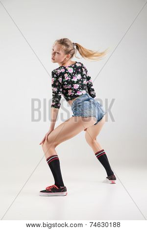 Beautiful booty dancer posing on studio background