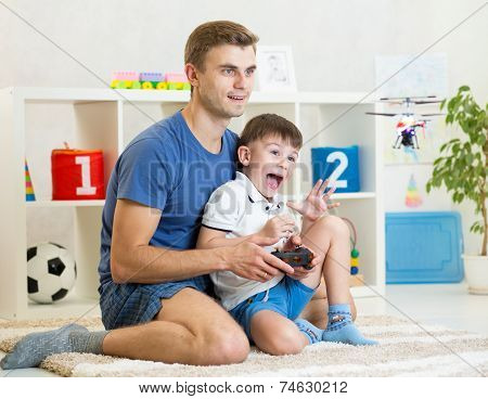 Father and son playing with RC helicopter toy
