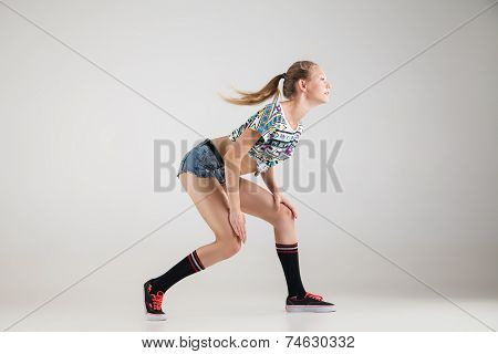 Beautiful booty dancer posing on studio background