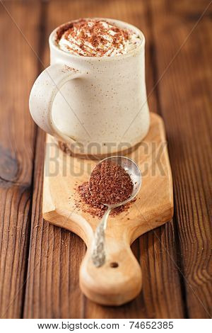 grated chocolate with hot chocolat vintage mug, topping with cream , shallow dof