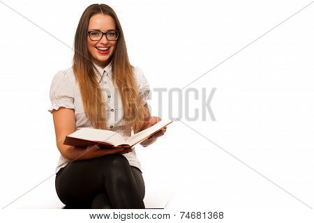 Happy Asian Caucasian Girl Lerning In Study Woth Lots Of Books On The Table
