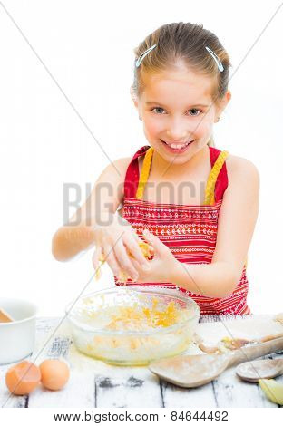 cutre little girl making dough, on a white background