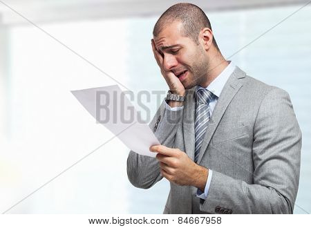 Portrait of a stressed businessman reading a document