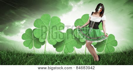 Irish girl smiling against orange and blue sky with clouds