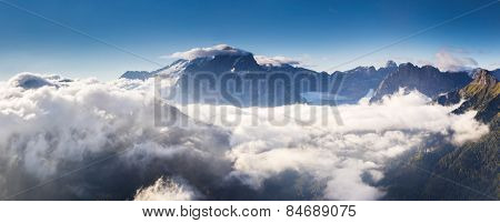 Great view of the foggy Val di Fassa valley with pass Sella. National Park. Dolomites (Dolomiti), South Tyrol. Location Canazei, Campitello, Mazzin. Italy, Europe. Dramatic scene. Beauty world.