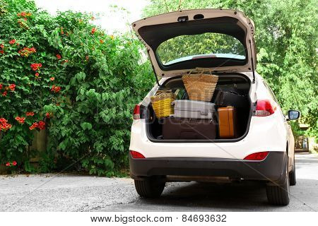 Suitcases and bags in trunk of car ready to depart for holidays