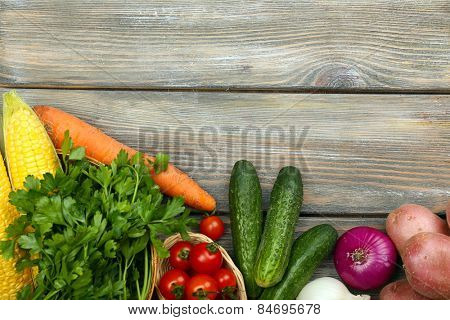 Summer frame with fresh organic vegetables and fruits on wooden background