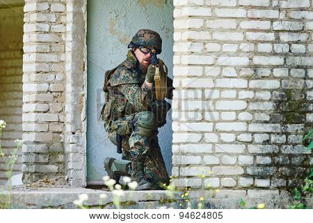 military. soldier targeting  with assault rifle at position in nato germany uniform indoors