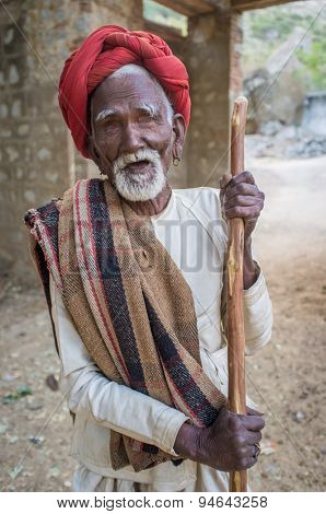 GODWAR REGION, INDIA - 13 FEBRUARY 2015: Blind Rabari tribesman holds stick in courtyard. Rabari or Rewari are an Indian community in the state of Gujarat.