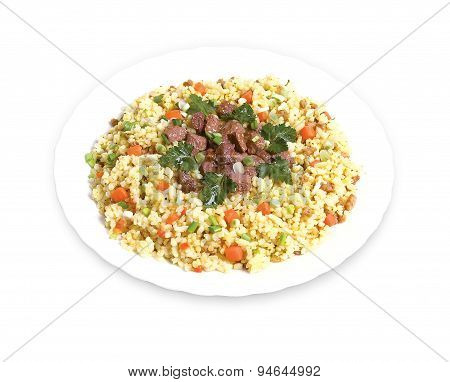 Pilaf with meat and greens on a plate