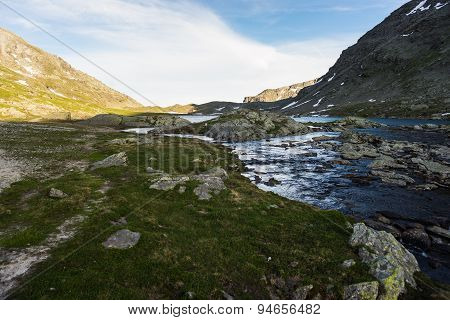 High Altitude Alpine Lake And Stream At Sunset