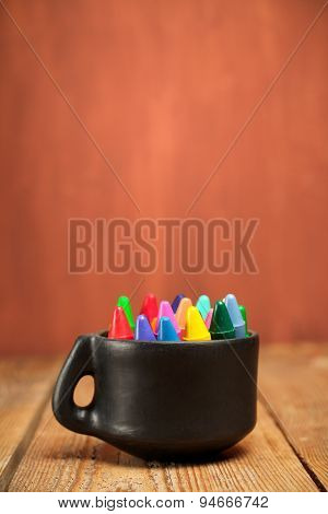 Crayons In A Mug On A Wooden Table