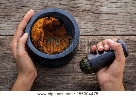 The Women Hold Pestle With Mortar And Spice Paste . The Red Paste Ingredients For Red Curry On Rusti