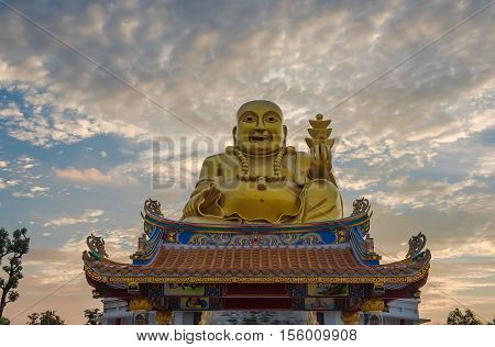 Golden Sangkat Ja Buddha with Twilight sky background.