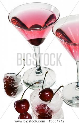 Red cocktail in martini glasses on white