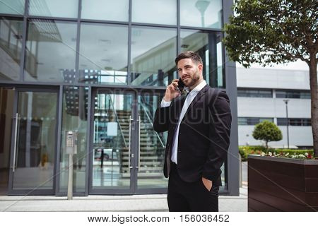Businessman talking on mobile phone in office premises