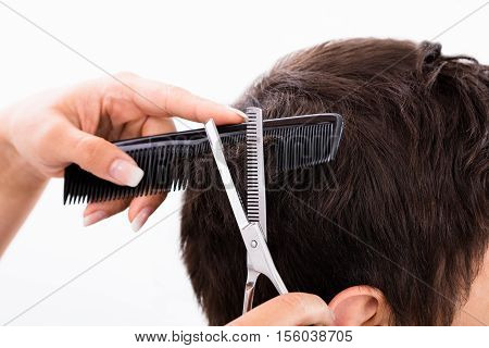 Close-up Of A Person Getting Haircut From Hairdresser In Salon