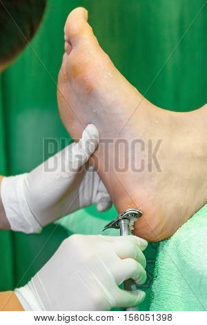 Pedicure  procedure in the beauty salon.  emover calluses on the feet. Foot care.