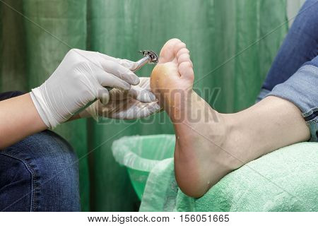 Pedicure  procedure in the beauty salon.  emover calluses on the feet. Foot care.