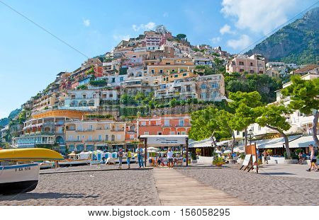 POSITANO ITALY - OCTOBER 5 2012: The colorful villas of the old town looks great from the central beach Marina Grande the best place to relax swim rent a boat or choose some cafe or restaurant on October 5 in Positano.