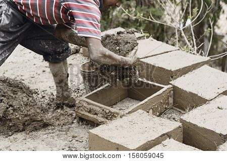 Boy Making Traditional Adobe Mud Bricks In Paru Paru Community Village, Pisaq District, Cusco Region