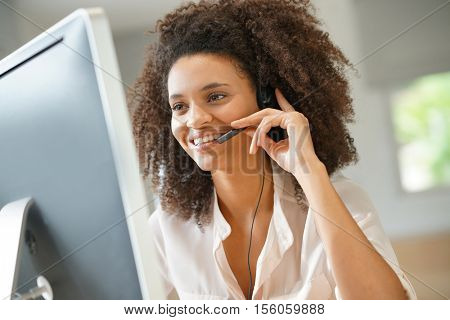 Portrait of customer service assistant talking on phone