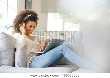 Cheerful woman making a videocall on laptop computer