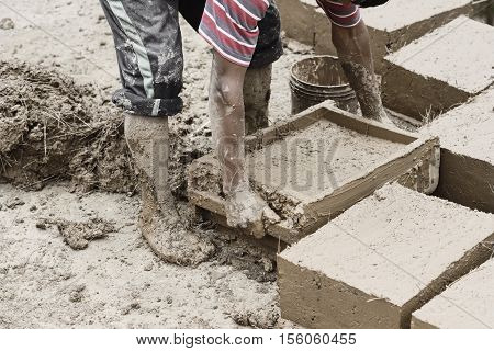 Boy Making Traditional Adobe Mud Bricks In Paru Paru Community Village, Pisaq District, Cusco Region