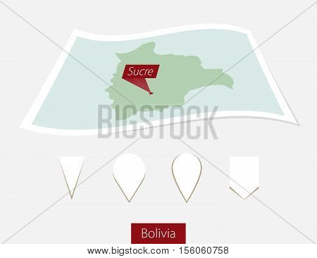 Curved Paper Map Of Bolivia With Capital Sucre On Gray Background. Four Different Map Pin Set.
