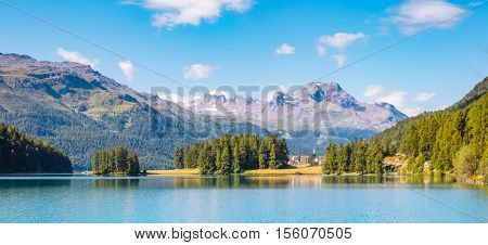 Great view of the azure pond Champfer in alpine valley. Popular tourist attraction. Picturesque and gorgeous scene. Location Swiss alps, Silvaplana village, district of Maloja, Europe. Beauty world.