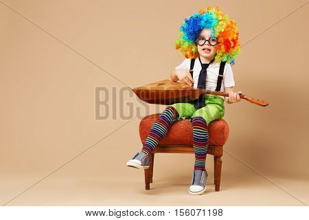 Blithesome Children. Happy Clown Boy In Large Neon Colored Wig Playing The Balalaika And Singing.