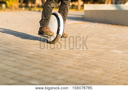 Man legs mono wheel personal electrical transport street outdoor