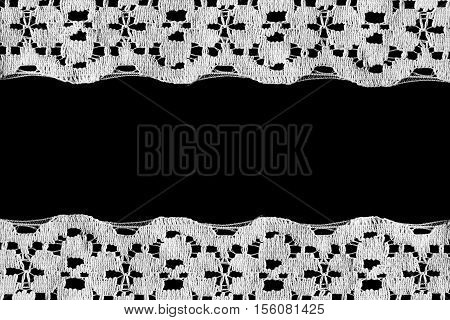 Vintage white lace as a frame on black background