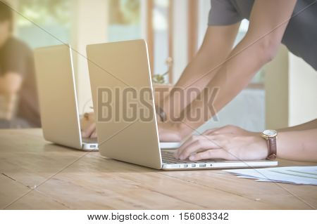 Hands Of Four Business People Working At Meeting. Group Support Concept. Vintage Effect. Soft Focus.
