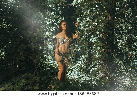 lovely hot young brunette girl in underwear leaf outdoors in the wood looking at the camera